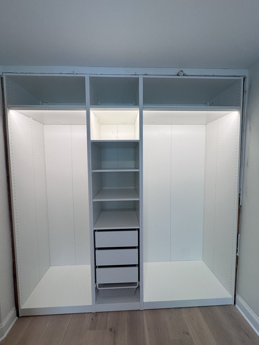Real ModuCloset installation — open closet interior showing shelving, drawers and hanging storage.