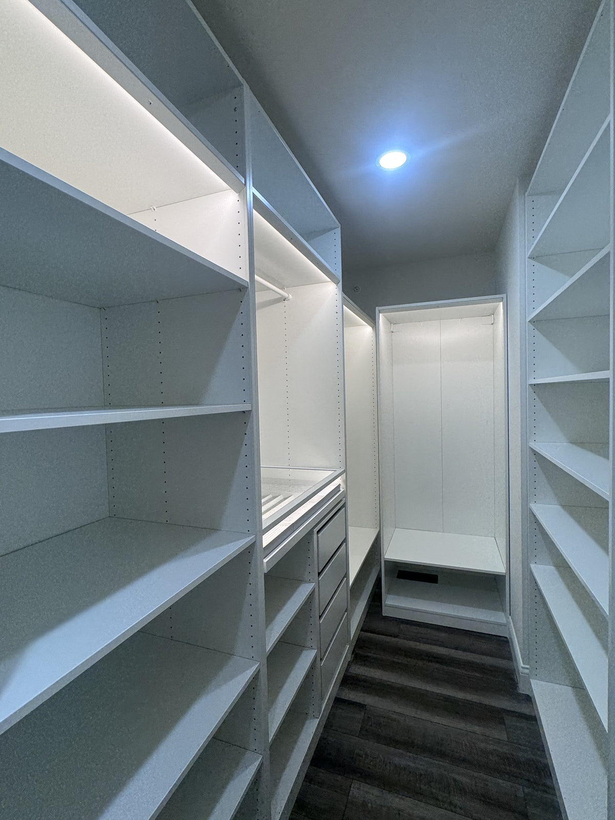 Real ModuCloset installation — alternate view of walk-in closet shelving and hanging layout.