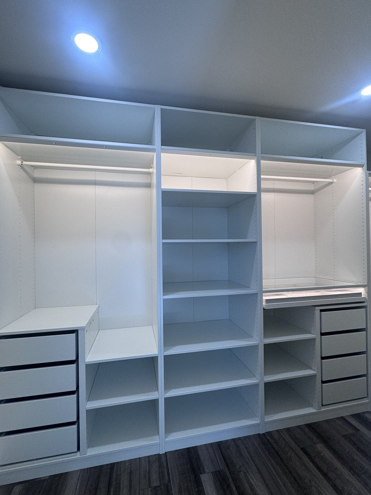 Real ModuCloset installation — wide storage wall with shelving, hanging bays and drawers.