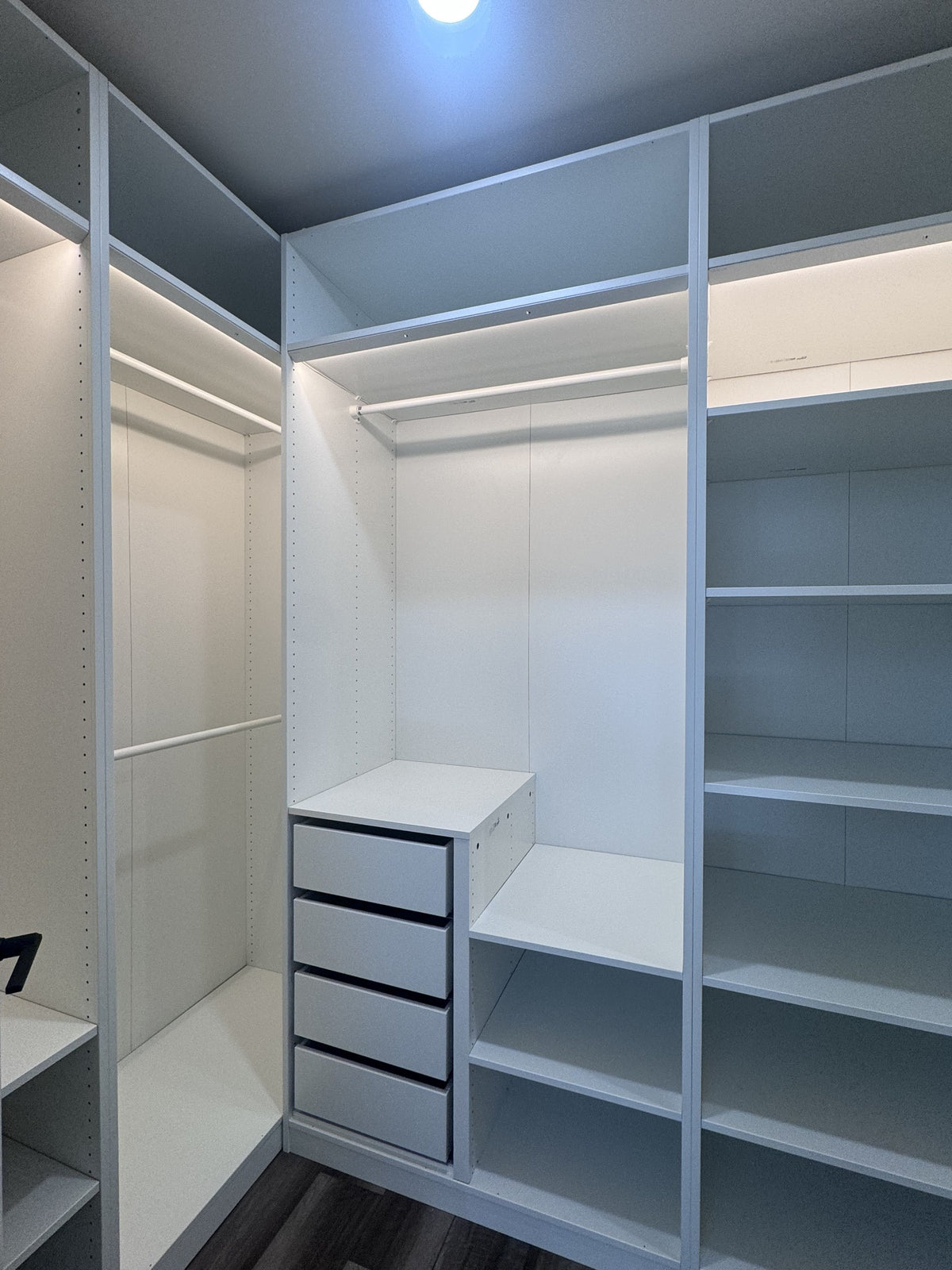 Real ModuCloset installation — corner hanging bay, shelves and drawer stack.