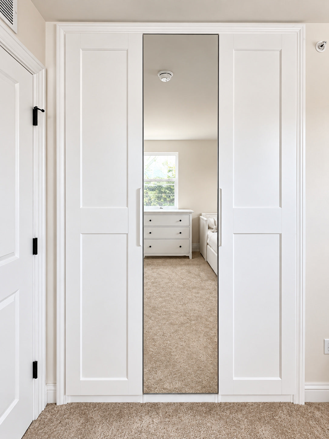Real ModuCloset Project 4 — straight-on finished white built-in closet with GRIMO doors and an AHEIM mirrored center door.